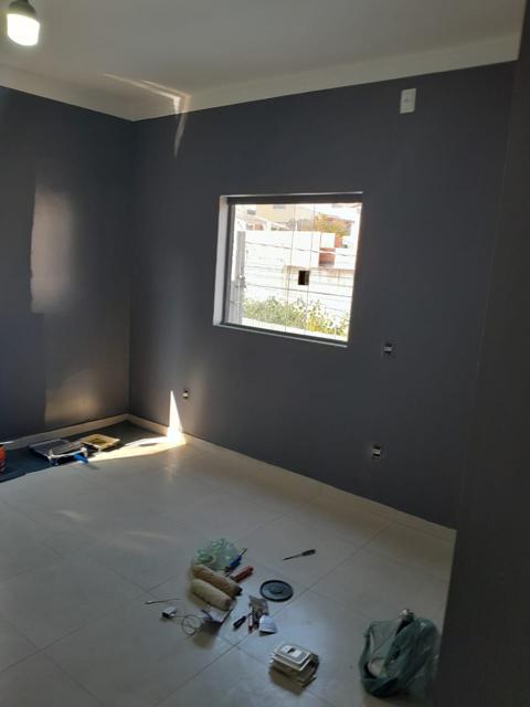 Quarto pintado em cinza com janela